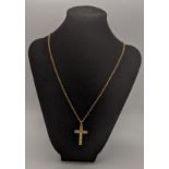 A 9ct gold cross pendant having a floral engraved design, on a gold necklace, tested as 9ct gold,