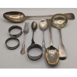Silver to include a bright cut engraved basting and serving spoon, three napkin rings a ladle and