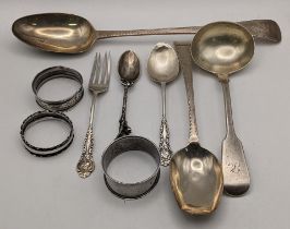 Silver to include a bright cut engraved basting and serving spoon, three napkin rings a ladle and