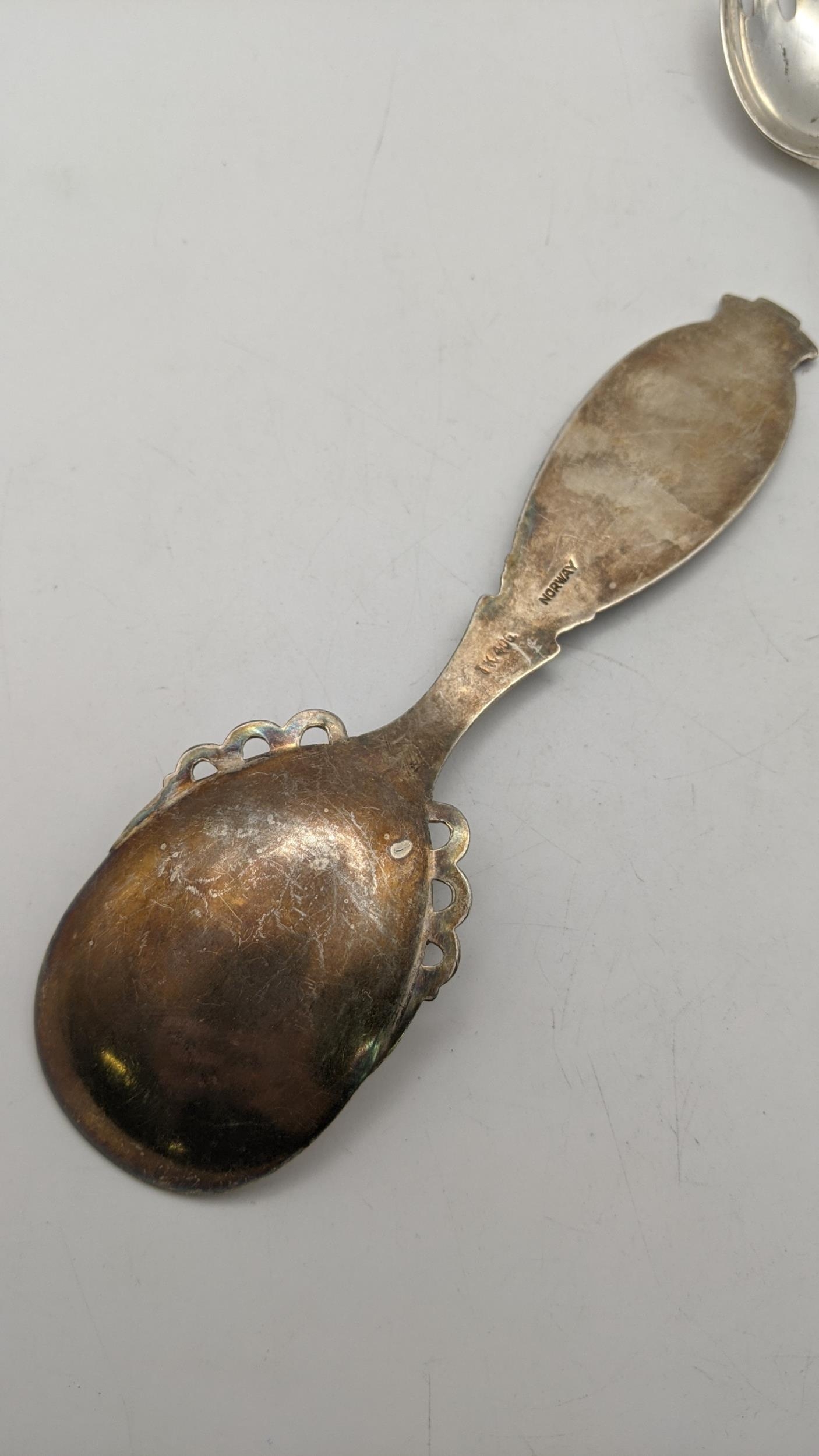 Silver flatware to include an elongated fork, sugar tongs, a Norwegian spoon 108g, and a mother of - Image 2 of 2