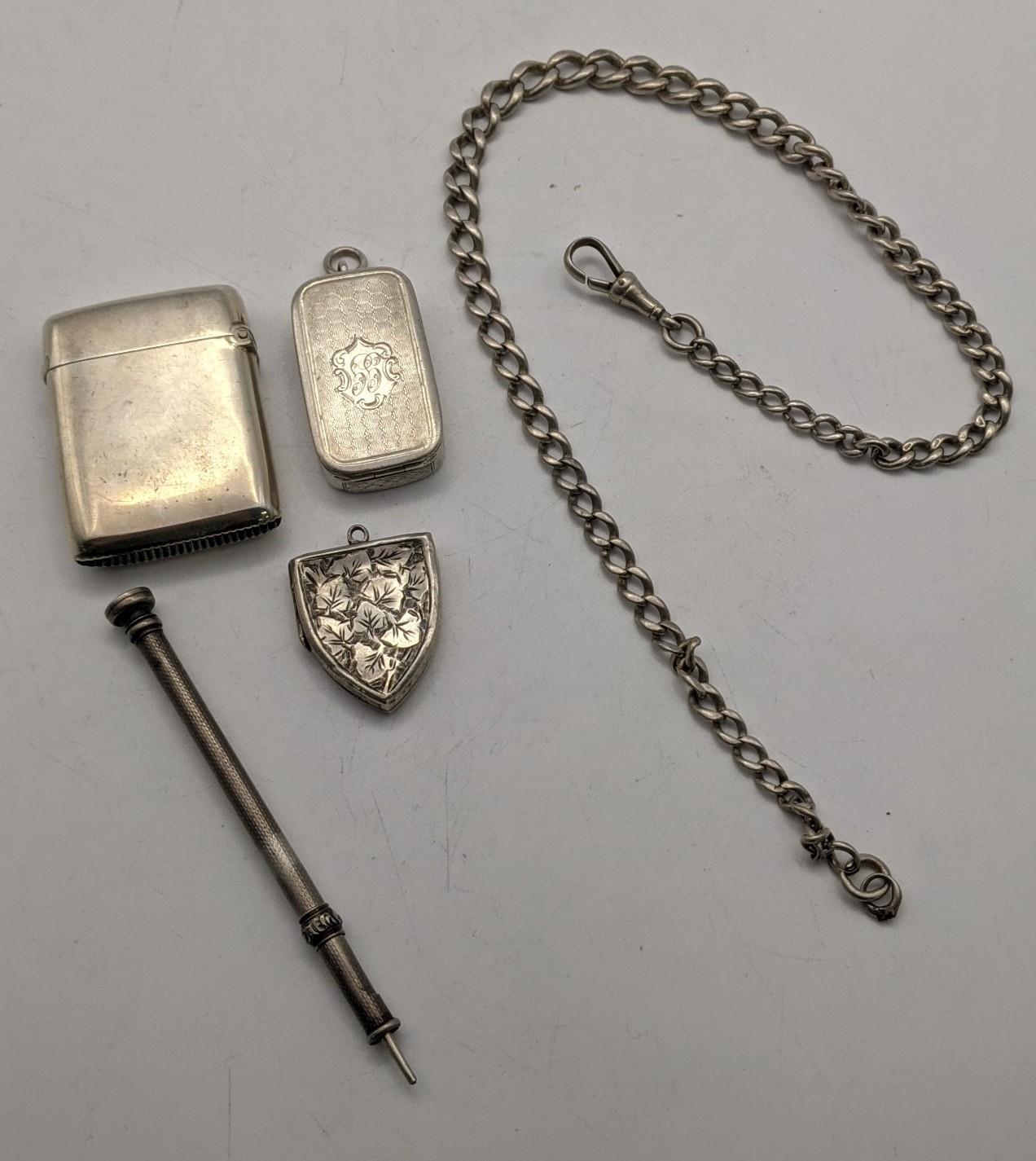 Mixed silver items to include a pocket watch chain and bulldog clip, two vesta cases, a silver