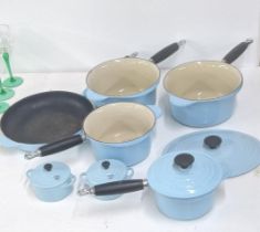 Le Creuset in duck egg blue to include a skillet, pots, a Dutch pot lid, a pair of crème brulee