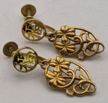 A pair of 14ct gold earrings having a floral pierced design Location