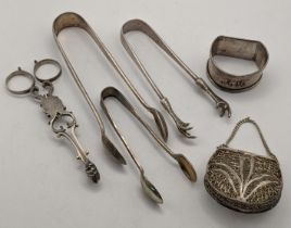 Silver and white metal to include George III silver sugar tongs, a napkin ring, a purse and tongs