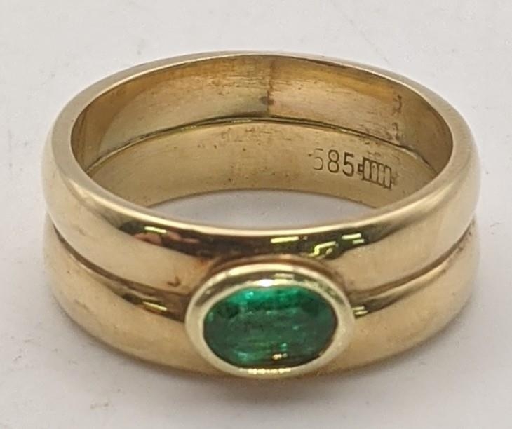 A 14ct gold double banded ring set with an emerald stamped 585 total weight 7.7g, size M½ Location:
