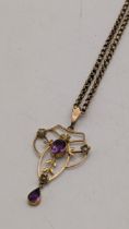 An Edwardian amethyst and seed pearl 9ct gold pendant on a yellow metal chain, 7.2g Location: