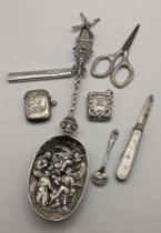 Silver to include a Dutch serving spoon, the bowl decorated with a boy having a tooth pulled, two