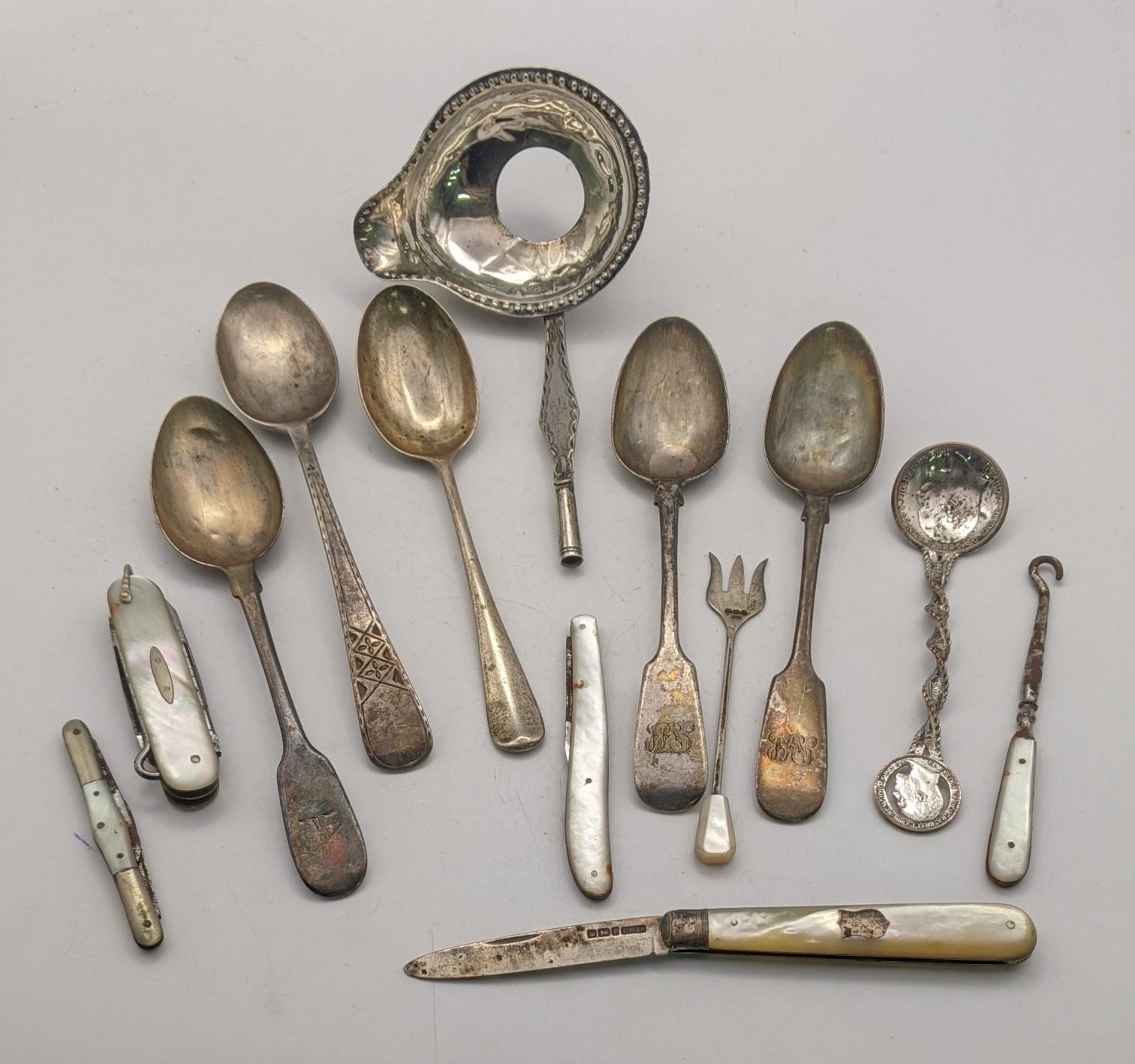 A mixed lot to include five silver spoons and a white metal toddy ladle 145.9g, along with a