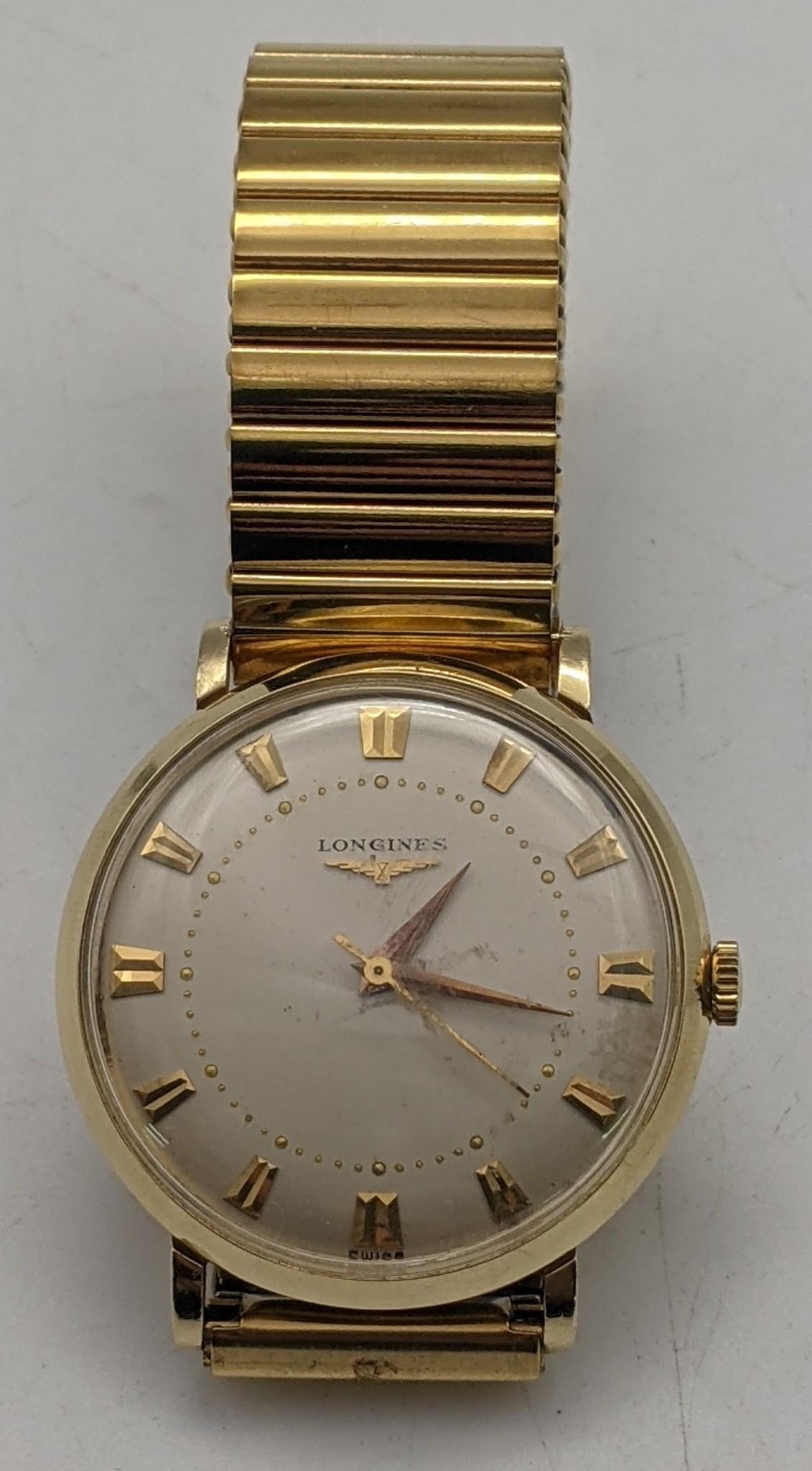 A 1950s 14ct gold Longines manual wind watch with engraving to the case back Location: