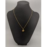 A 18ct gold pendant fashioned as a elephants set with a diamond on a 18ct gold necklace, total