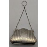 An Edwardian silver purse with a leather interior Location: