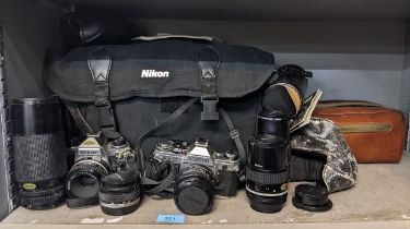 Photographic equipment to include a Nikon and a Canon AE-1 camera, 70-210 75-150 lenses, Olympus
