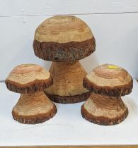 A pair of carved pine mushrooms 30cm high and a larger example 50cm high Location: G