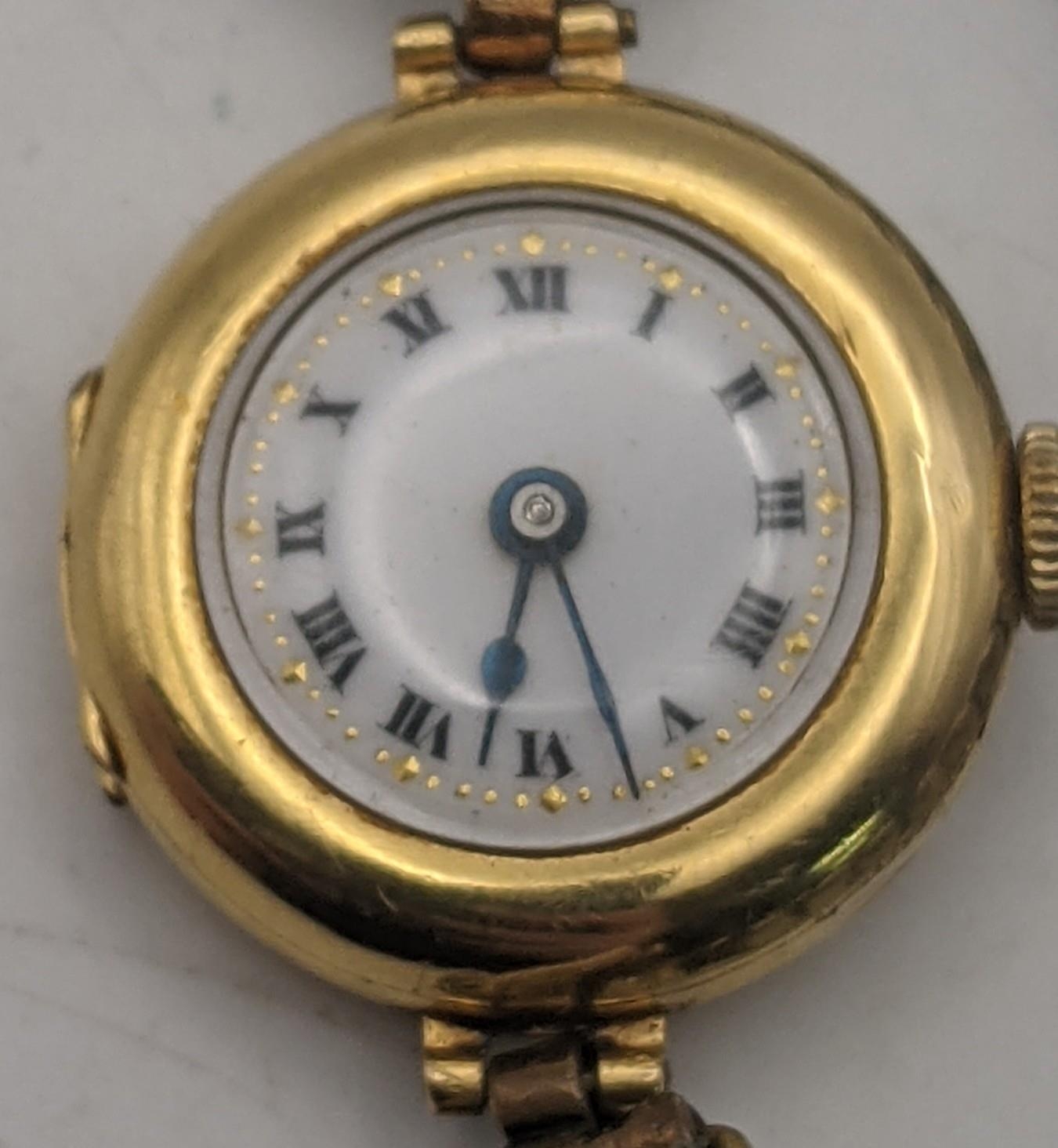 An early 20th century 18ct gold ladies manual wind wristwatch with a later expanding strap, total