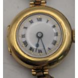 An early 20th century 18ct gold ladies manual wind wristwatch with a later expanding strap, total