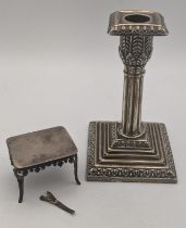 A silver miniature table, together with a weighted silver candlestick hallmarked Sheffield 1893