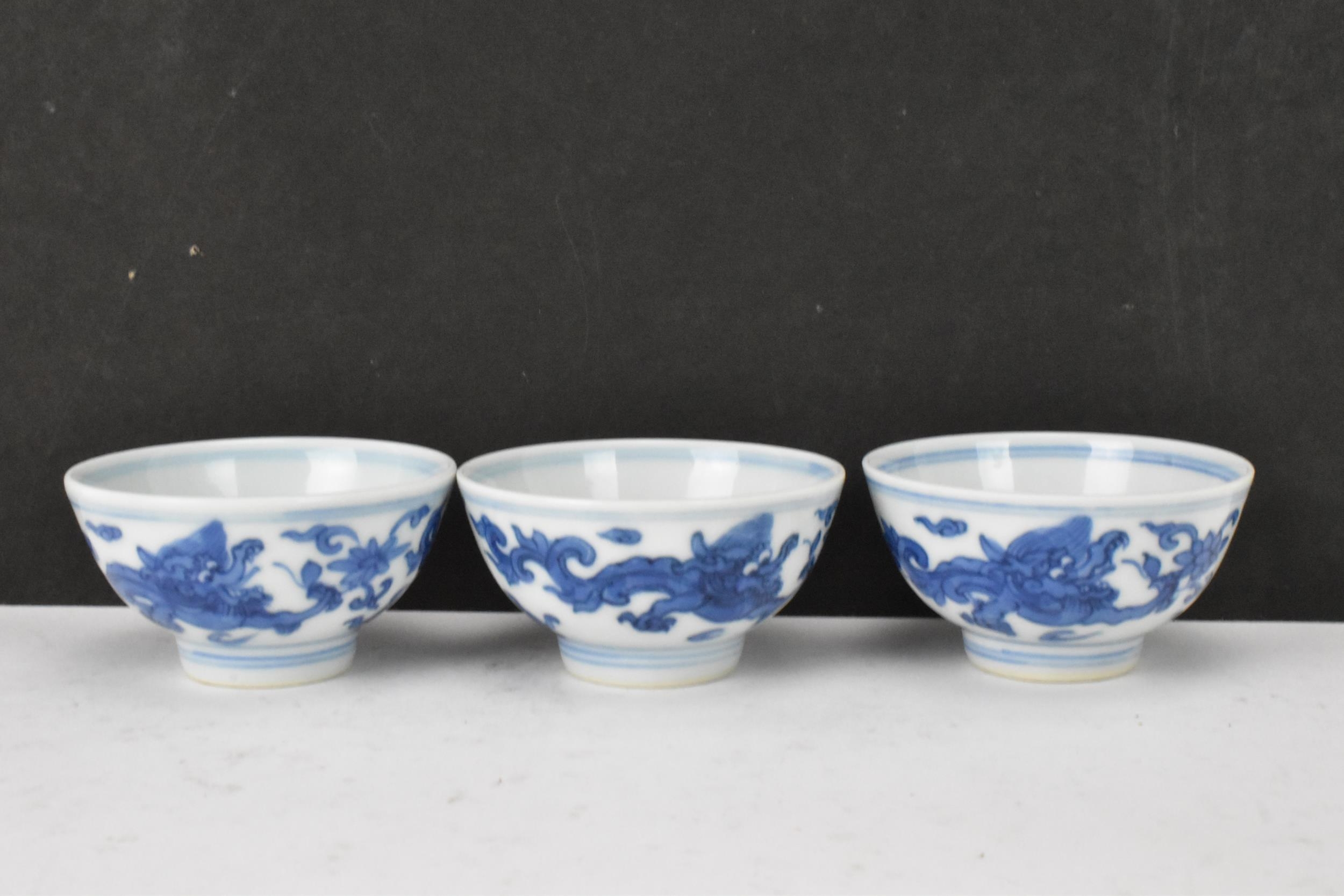 Three Chinese 20th century blue and white bowls, decorated with dragons and interiors with central - Image 2 of 9