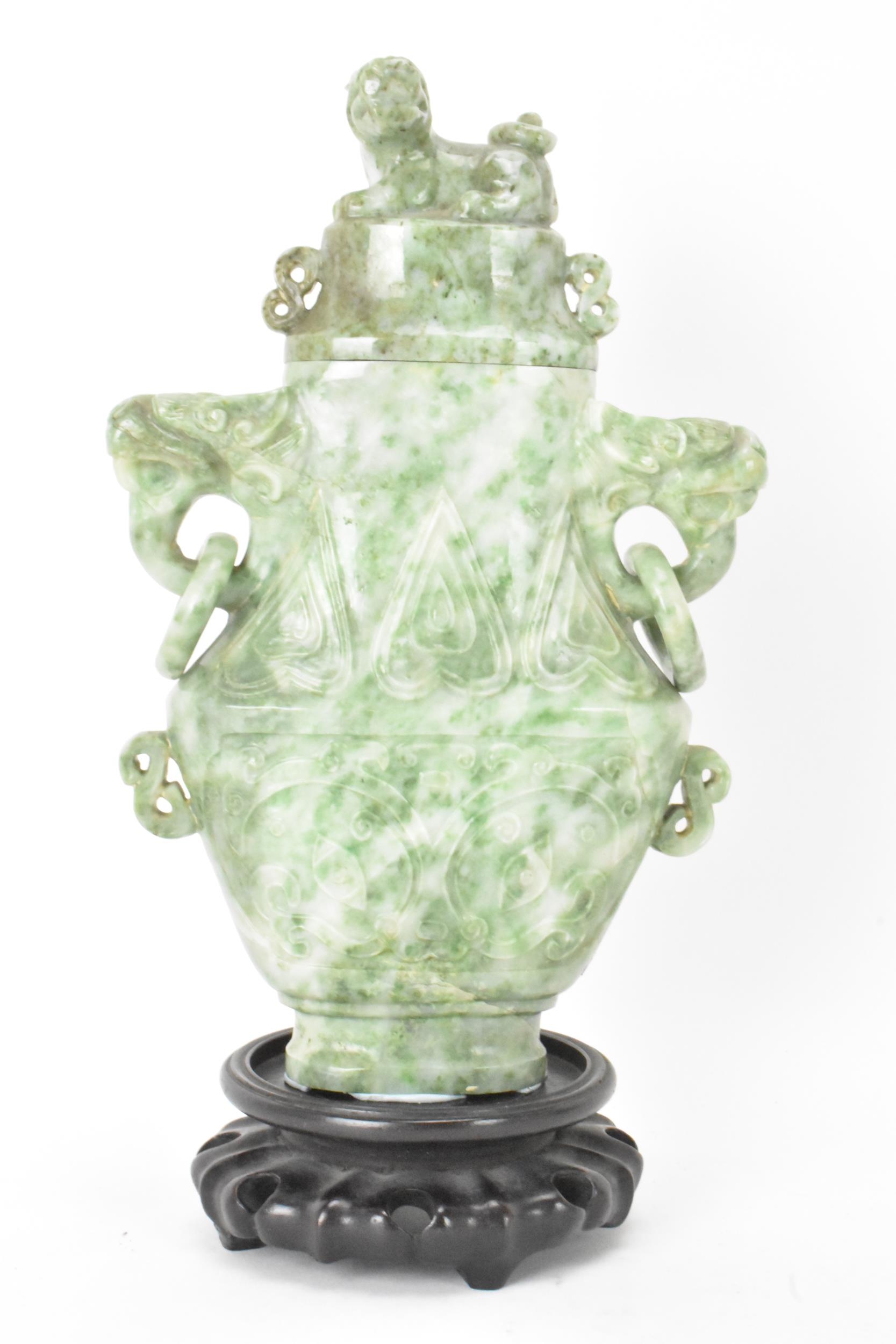 A Chinese 20th century jadeite vase, of flattened baluster shape with archaistic relief