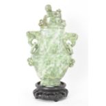 A Chinese 20th century jadeite vase, of flattened baluster shape with archaistic relief