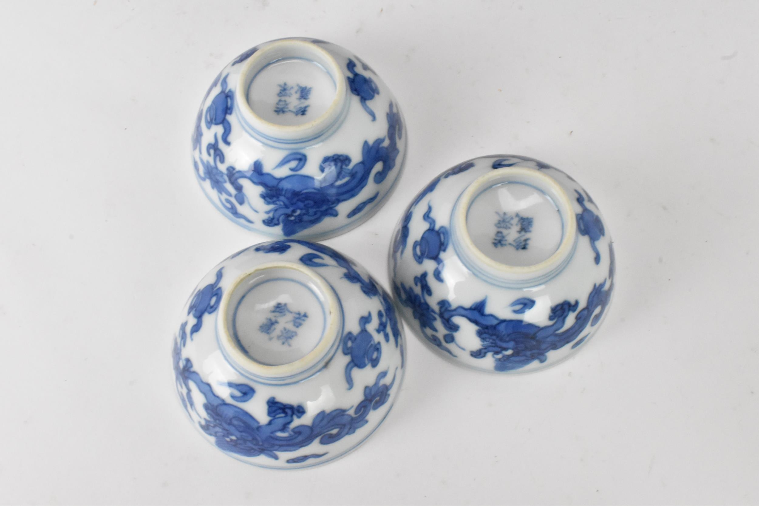 Three Chinese 20th century blue and white bowls, decorated with dragons and interiors with central - Image 5 of 9