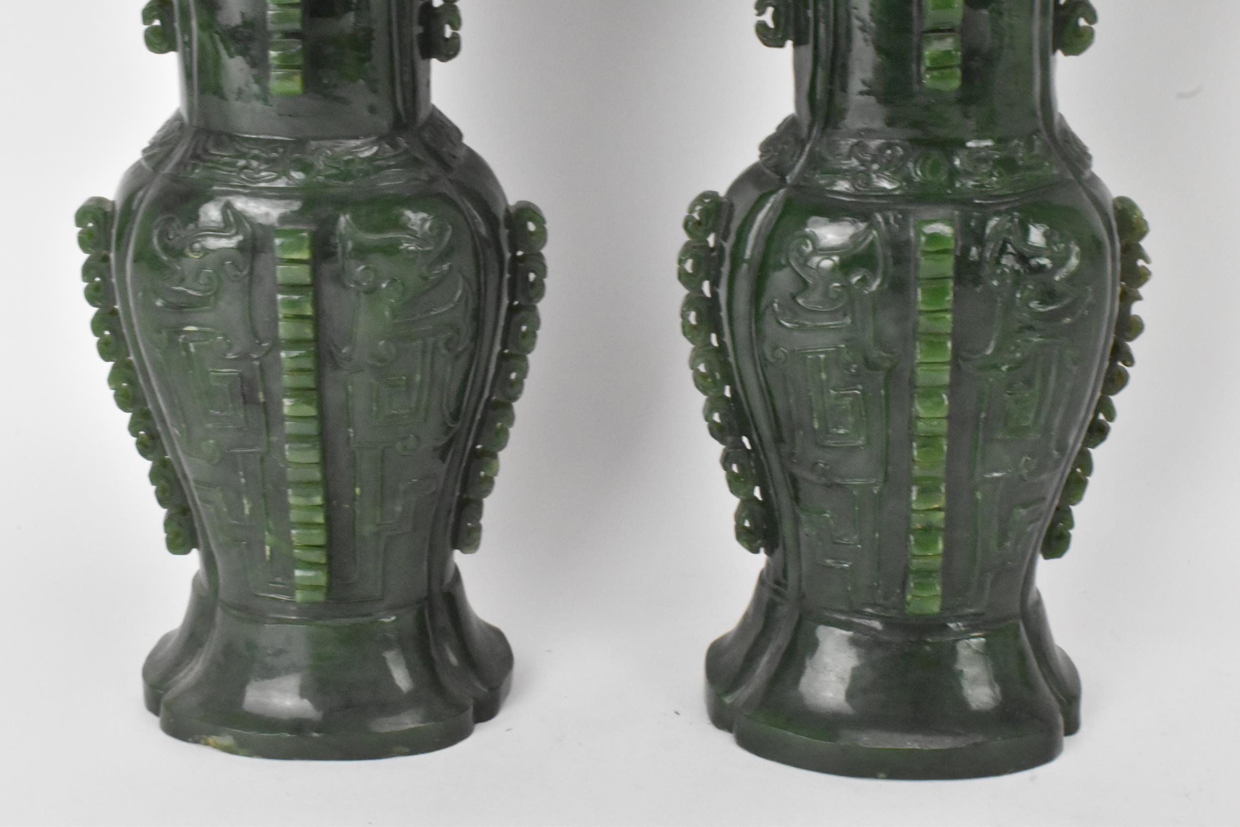 A pair of Chinese 20th century jadeite vases, of flattened baluster shape with archaistic relief - Image 3 of 7