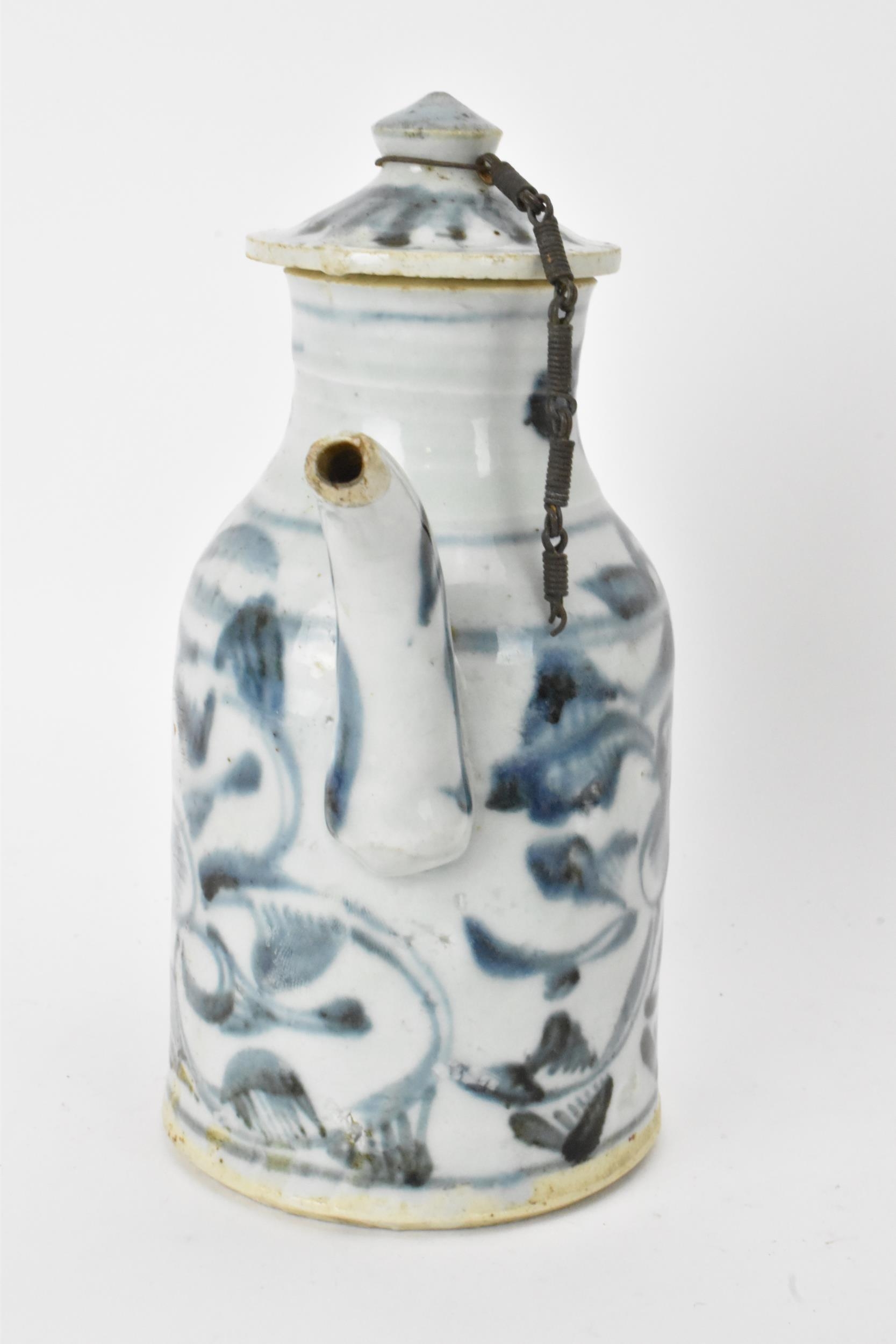 A Chinese ewer, late Ming dynasty, decorated in underglaze blue with flowers, loop shaped handle and - Image 2 of 7