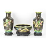 A pair of Chinese mid 20th century cloisonne vases and a bowl, all with black grounds decorated with