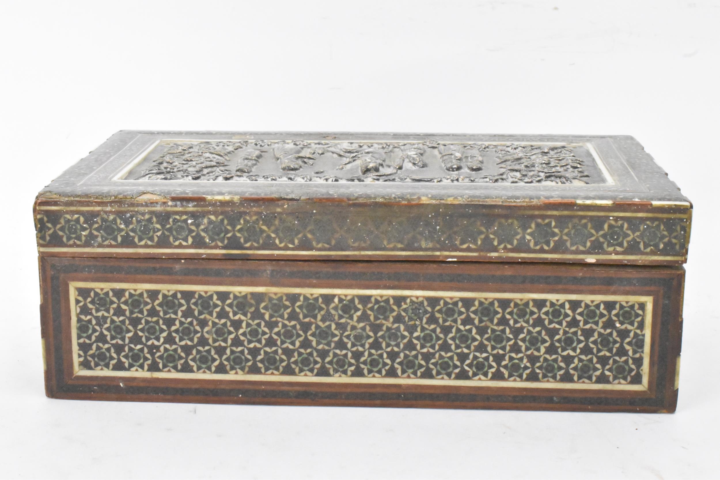 A late 19th century Indo-Persian cigarette box, decorated with a silver repousse panel to the lid - Image 4 of 7