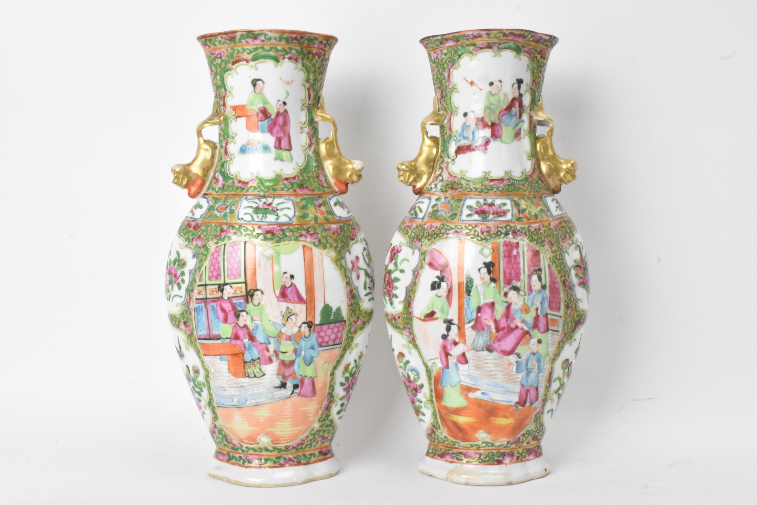 A pair of Chinese export Canton Famille Rose vases, Qing Dynasty, late 19th century, in polychrome