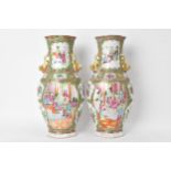 A pair of Chinese export Canton Famille Rose vases, Qing Dynasty, late 19th century, in polychrome