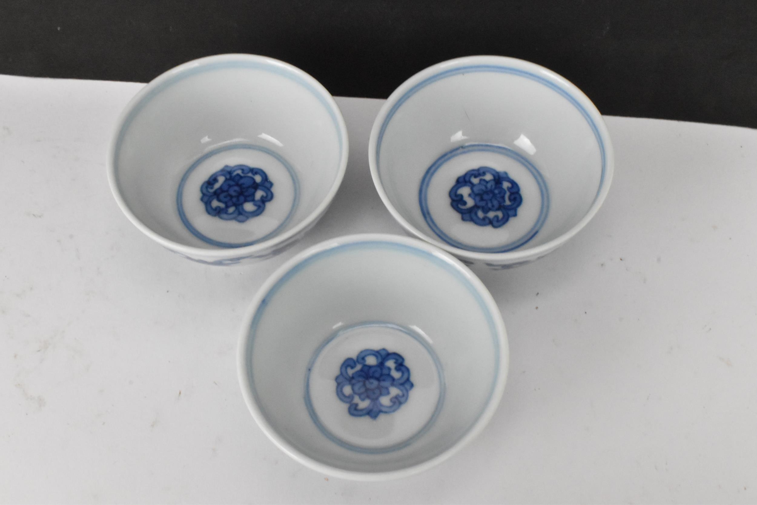 Three Chinese 20th century blue and white bowls, decorated with dragons and interiors with central - Image 4 of 9