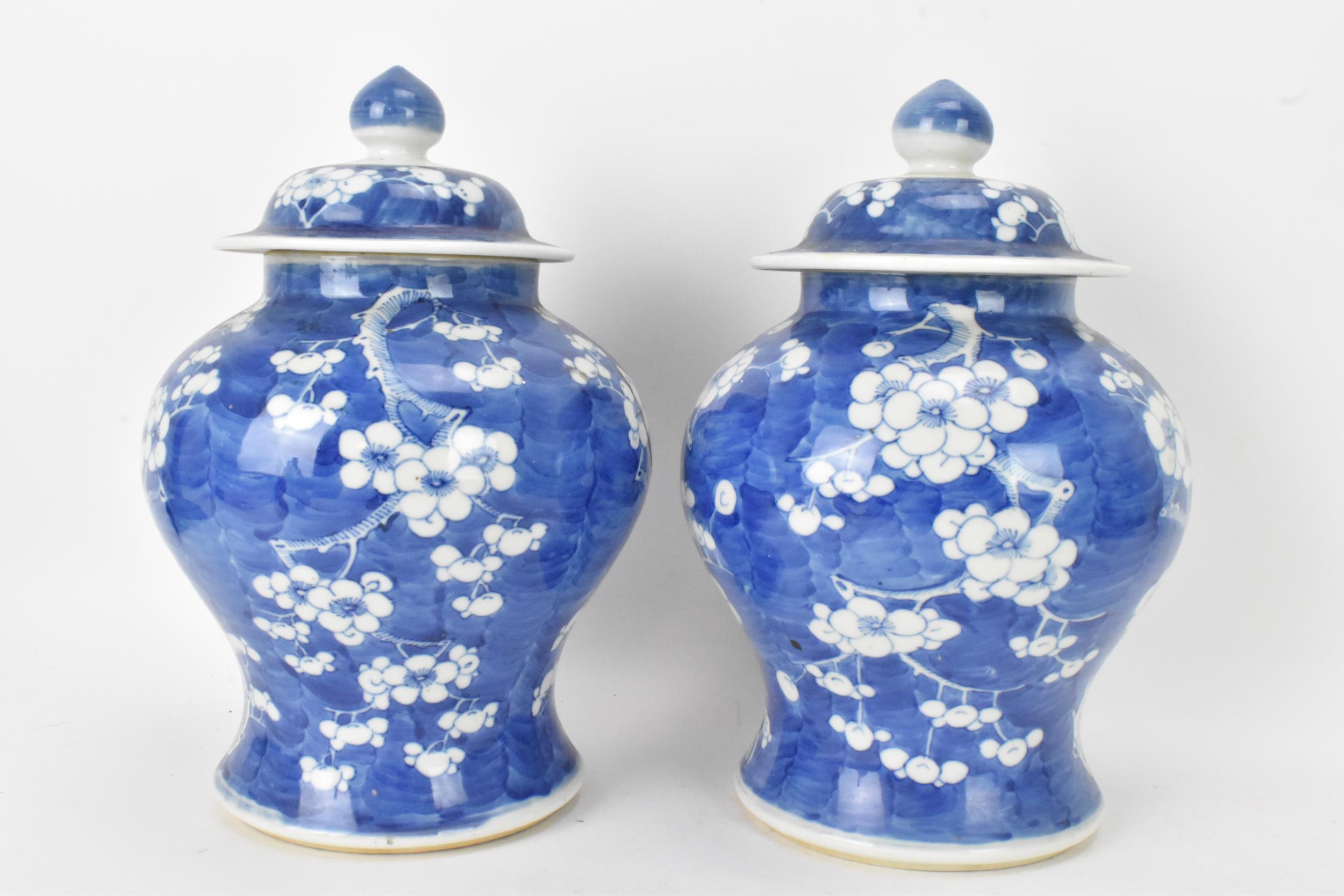 A pair of Chinese prunus pattern blue and white vases, late Qing Dynasty, both of baluster form with - Image 2 of 8