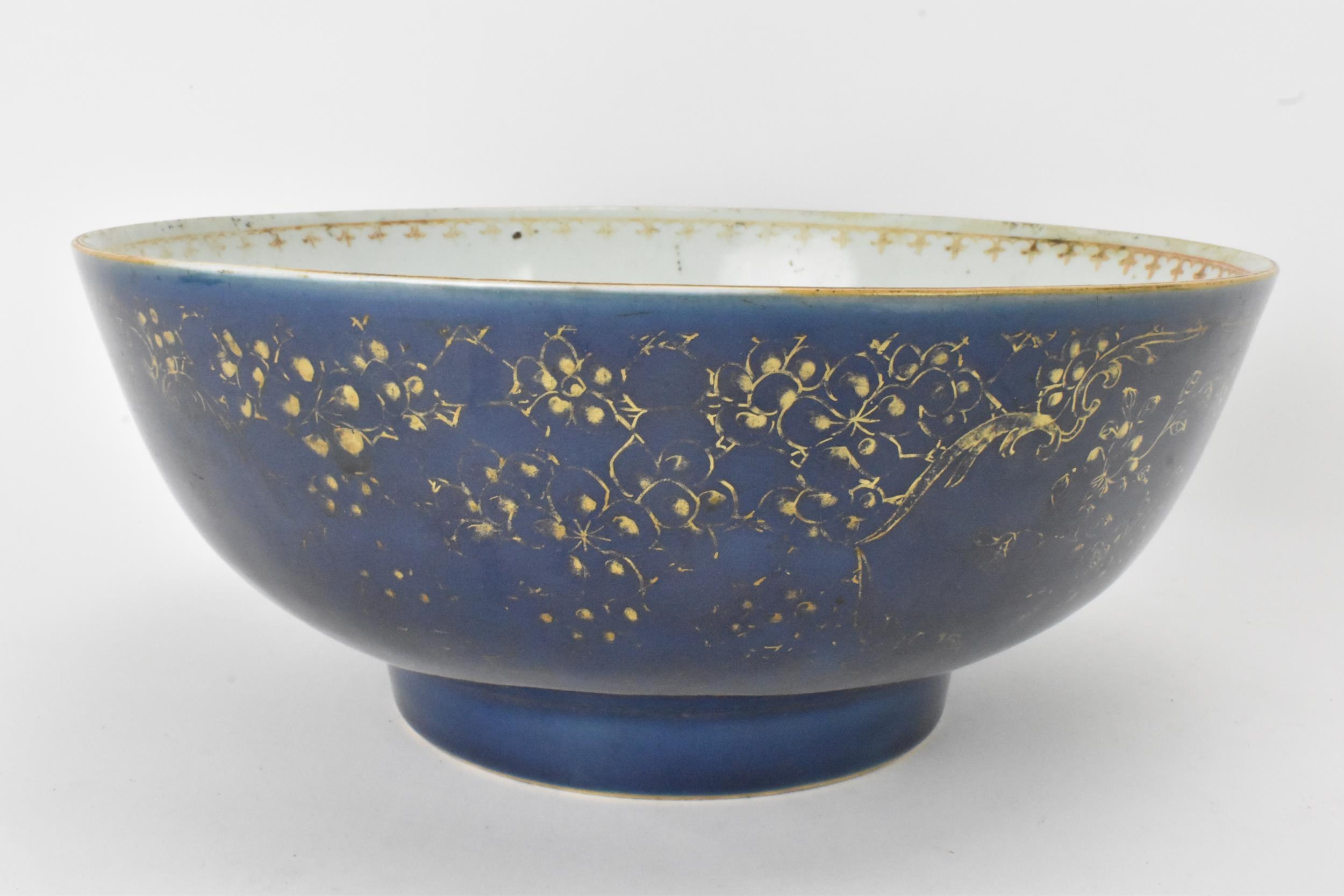 A large Chinese export Qianlong footed bowl, in a powder blue glaze and decorated with gilt flora to
