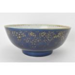 A large Chinese export Qianlong footed bowl, in a powder blue glaze and decorated with gilt flora to