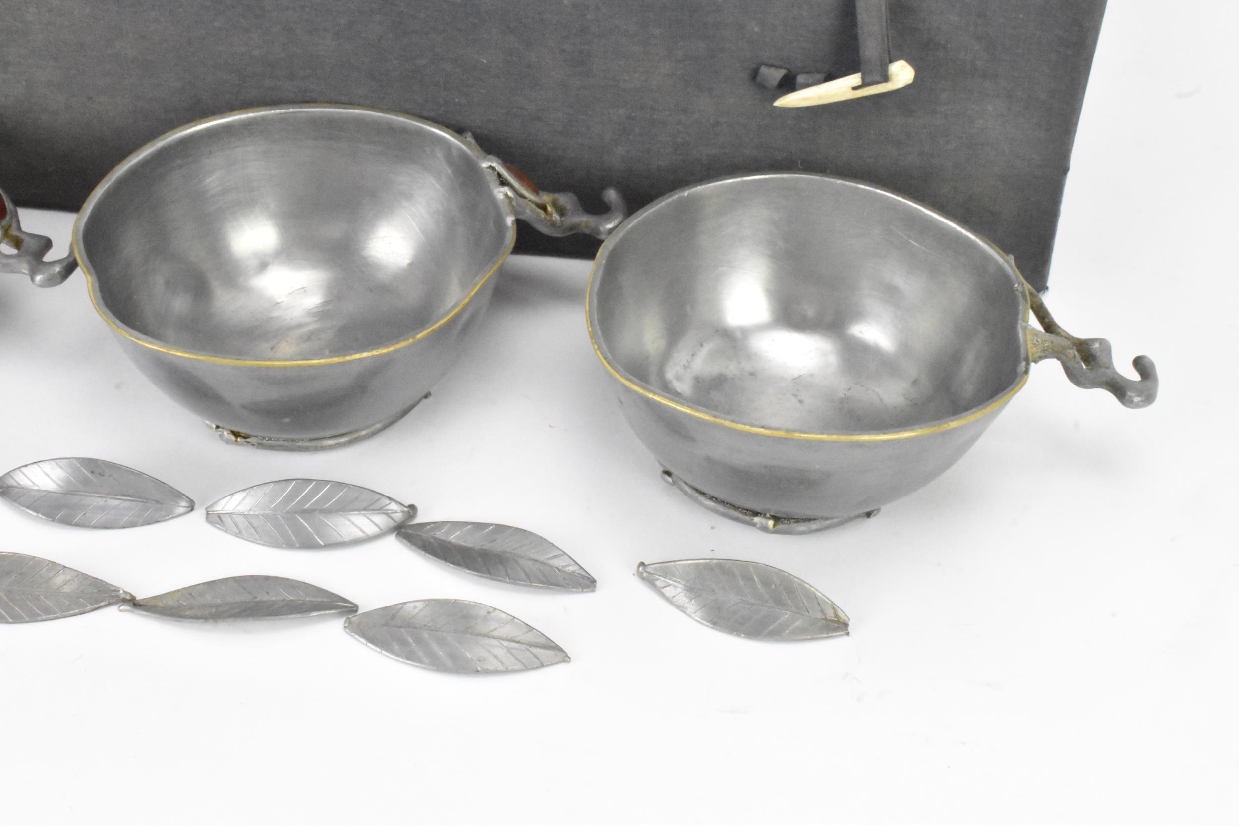 A set of six Chinese pewter bowls, each having a shaped rim and fluted body, the handles in the form - Image 5 of 6