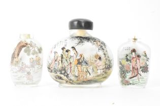 Three Chinese 20th century glass painted snuff bottles, one depicting figures in conversation in a