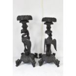 A pair of late 19th century Anglo-Indian colonial ebonized carved plant stands, each having ornately