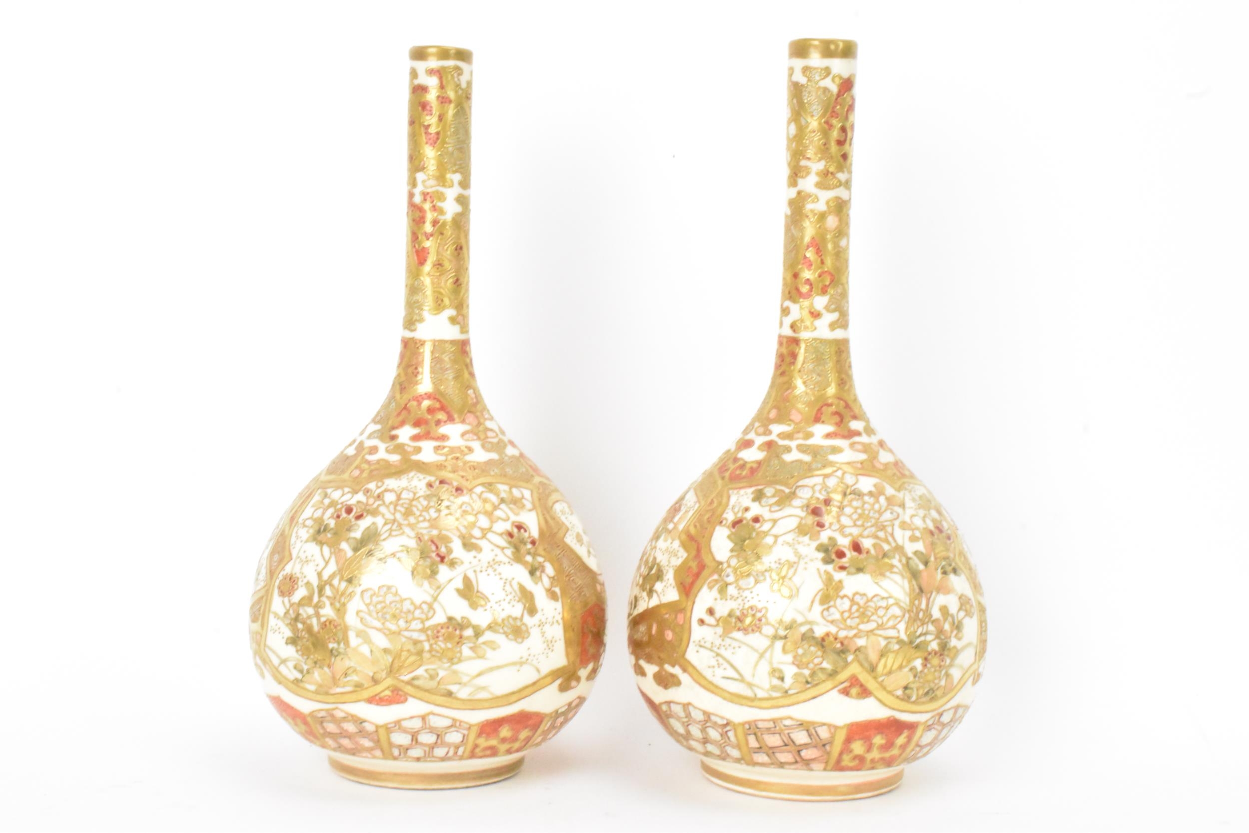 A pair of Japanese Meiji period satsuma bottle neck vases, of onion shape with shaped cartouches