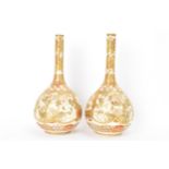 A pair of Japanese Meiji period satsuma bottle neck vases, of onion shape with shaped cartouches