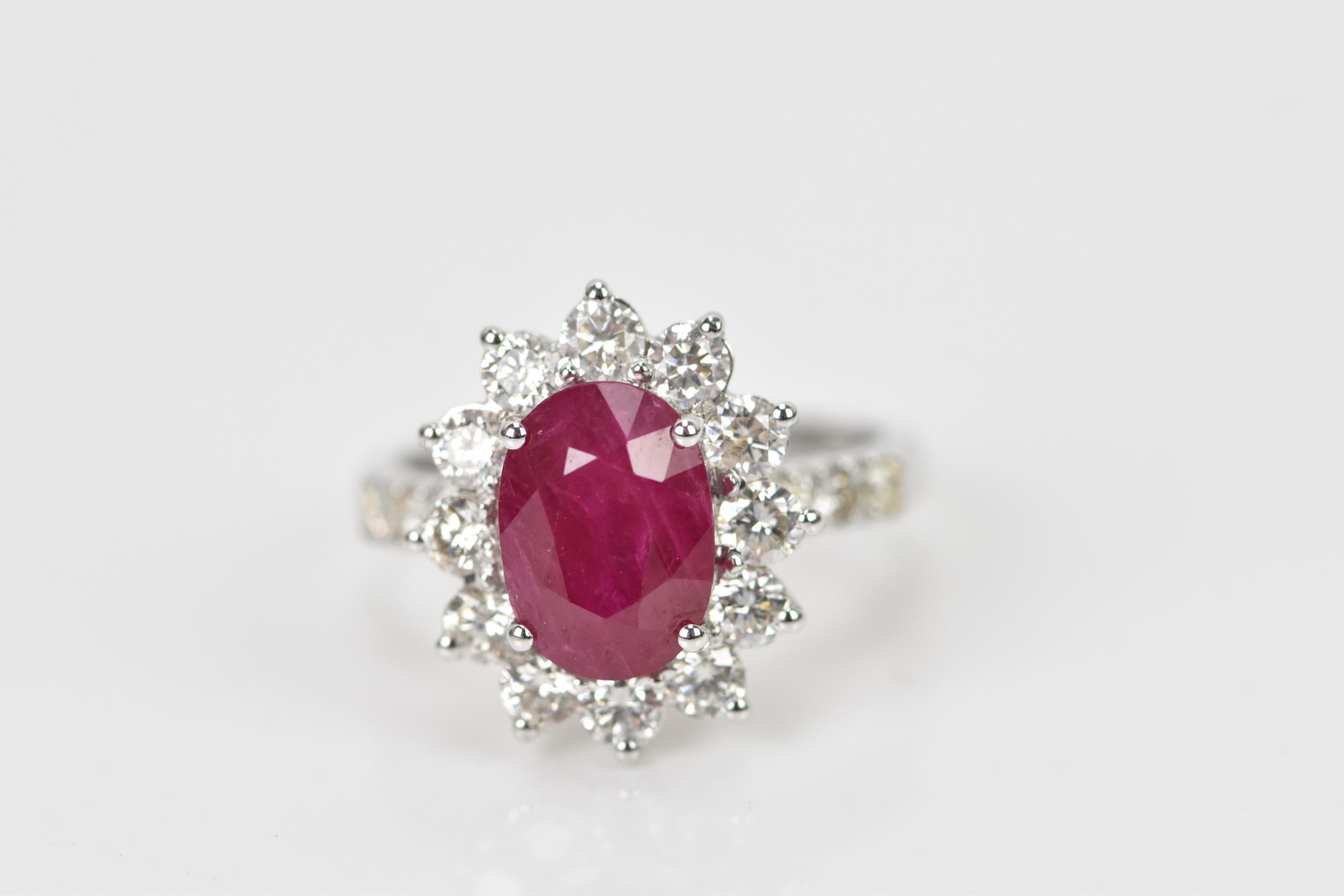 An 18ct white gold, diamond and ruby dress ring, set with central oval mixed cut ruby in four claw - Bild 12 aus 12