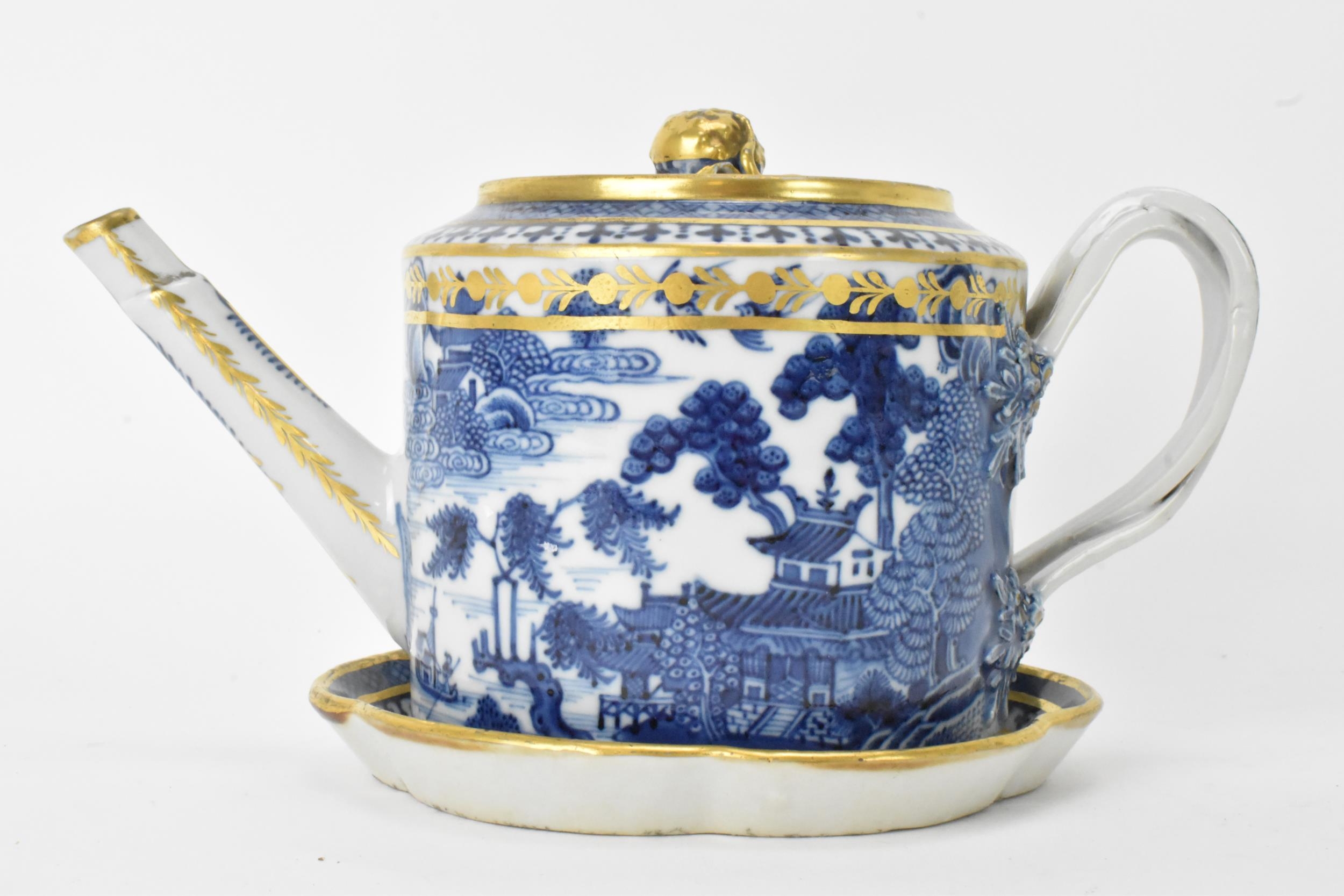 A Chinese export Qing dynasty blue and white teapot and stand, late 18th century, decorated with