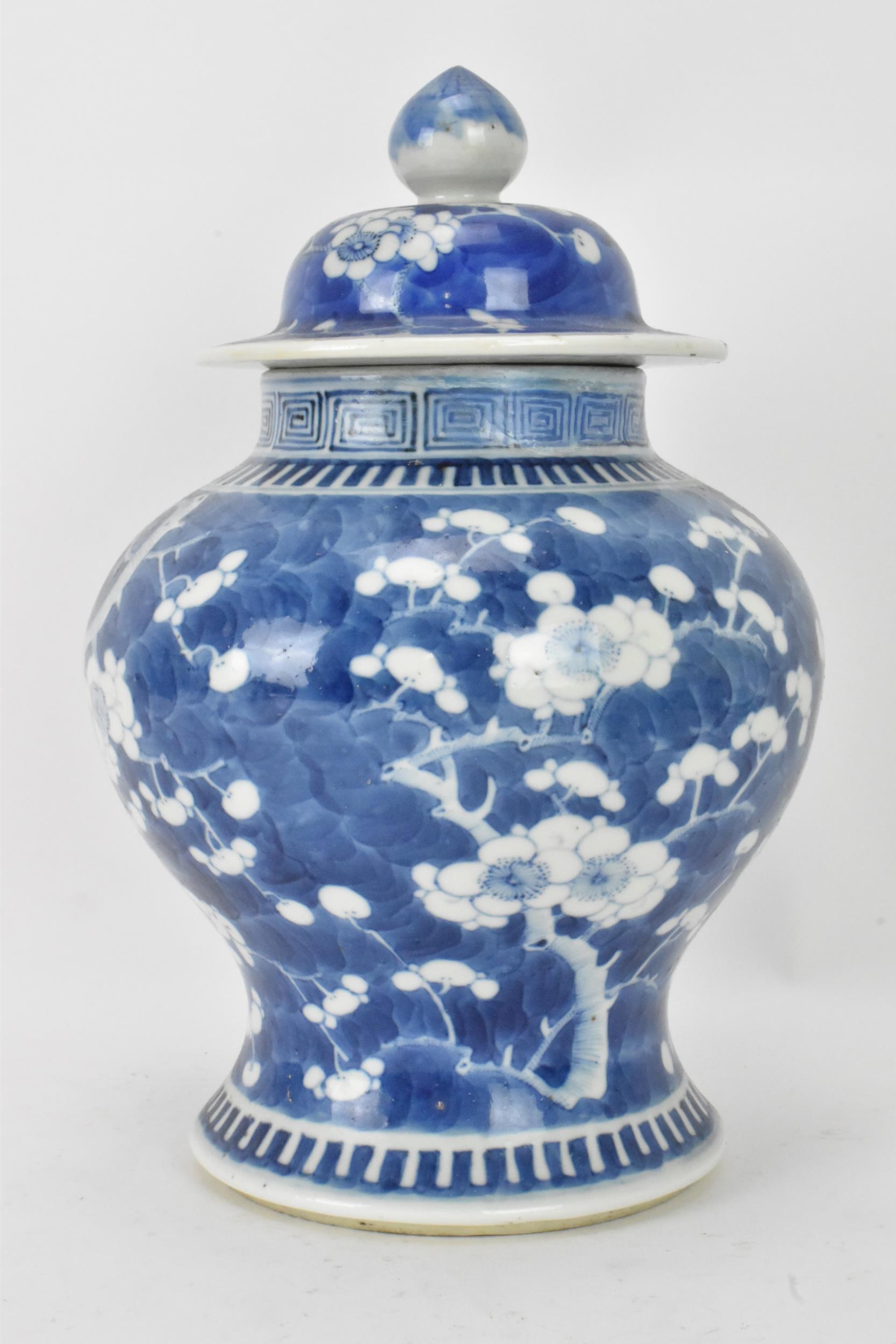 A Chinese prunus pattern blue and white vase, late Qing Dynasty, of baluster form with domed cover - Image 4 of 8