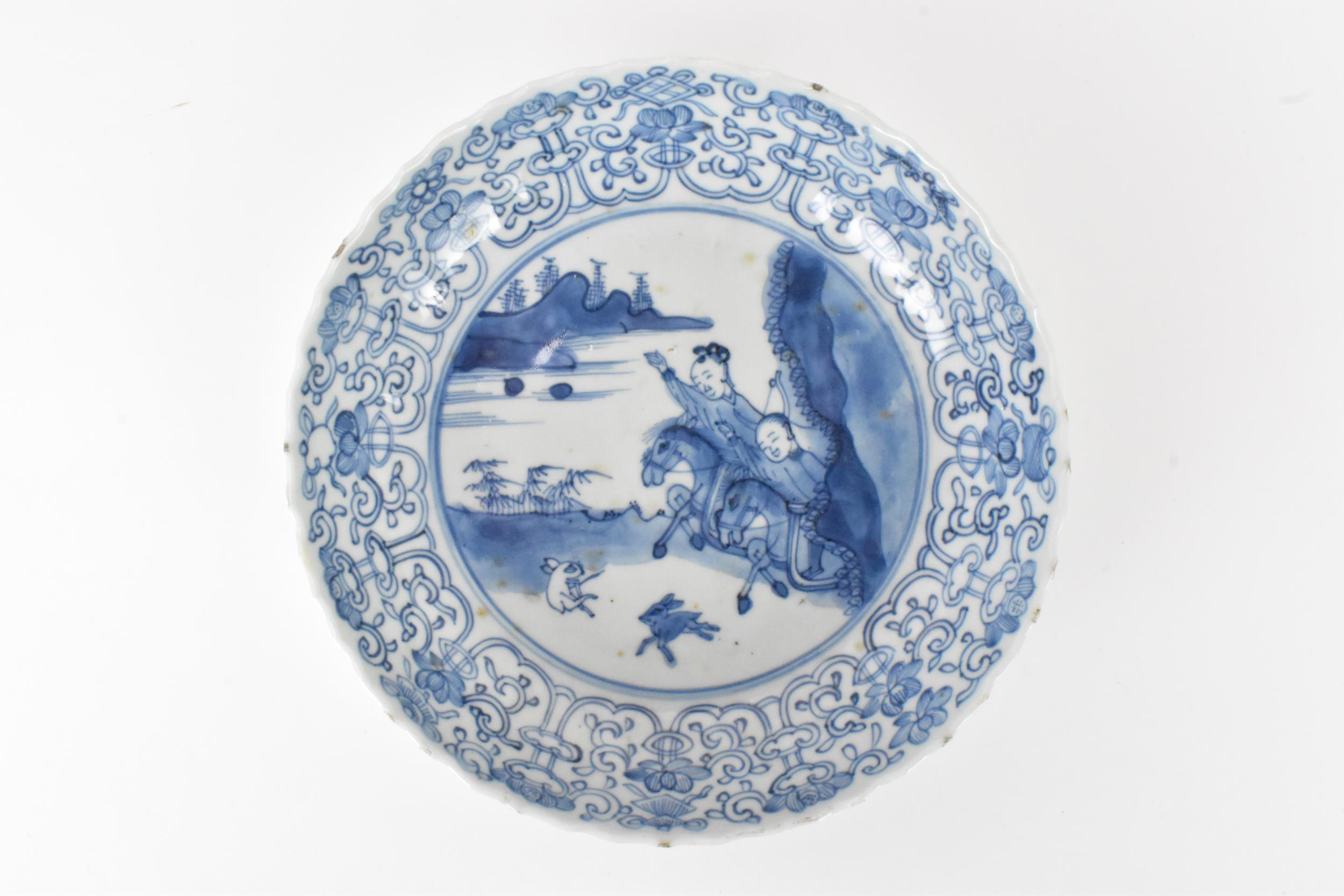 A pair of Qing Dynasty blue and white dishes, with fluted sides and barbed rim, decorated on the - Image 3 of 9