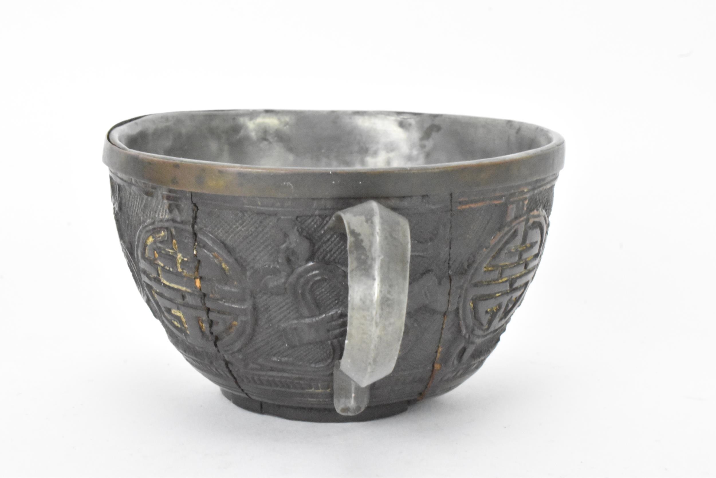 A Chinese late 19th/early 20th century coconut carved cup and saucer, both with pewter liners and - Image 4 of 8