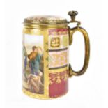 A brass-mounted Royal Vienna porcelain tankard, of cylindrical form painted with a figurative