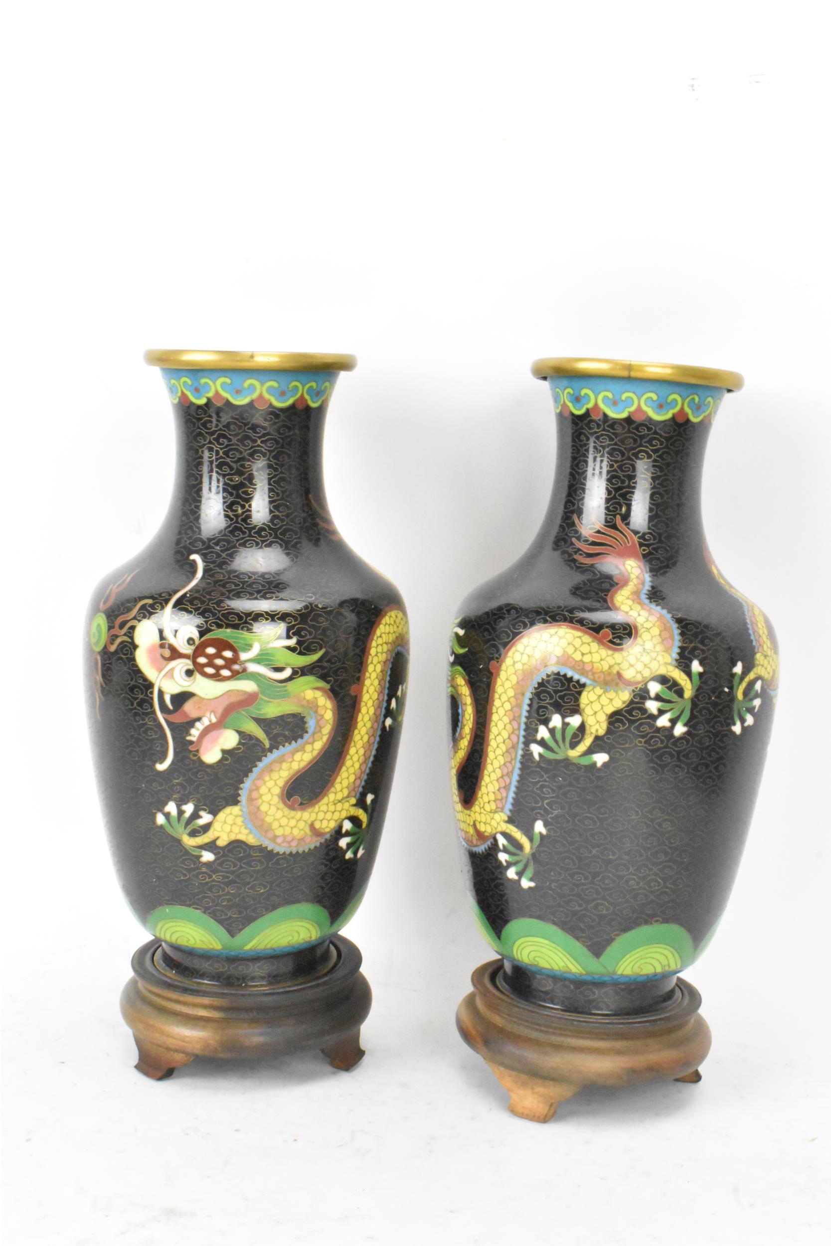 A pair of Chinese mid 20th century cloisonne vases, with black grounds decorated with confronting - Image 2 of 6