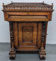 A late Victorian walnut centre pedestal cabinet, having a pierced gallery with turned ball