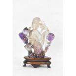A 20th century Chinese carved amethyst figure of Guanyin, the goddess of mercy, in a seated position