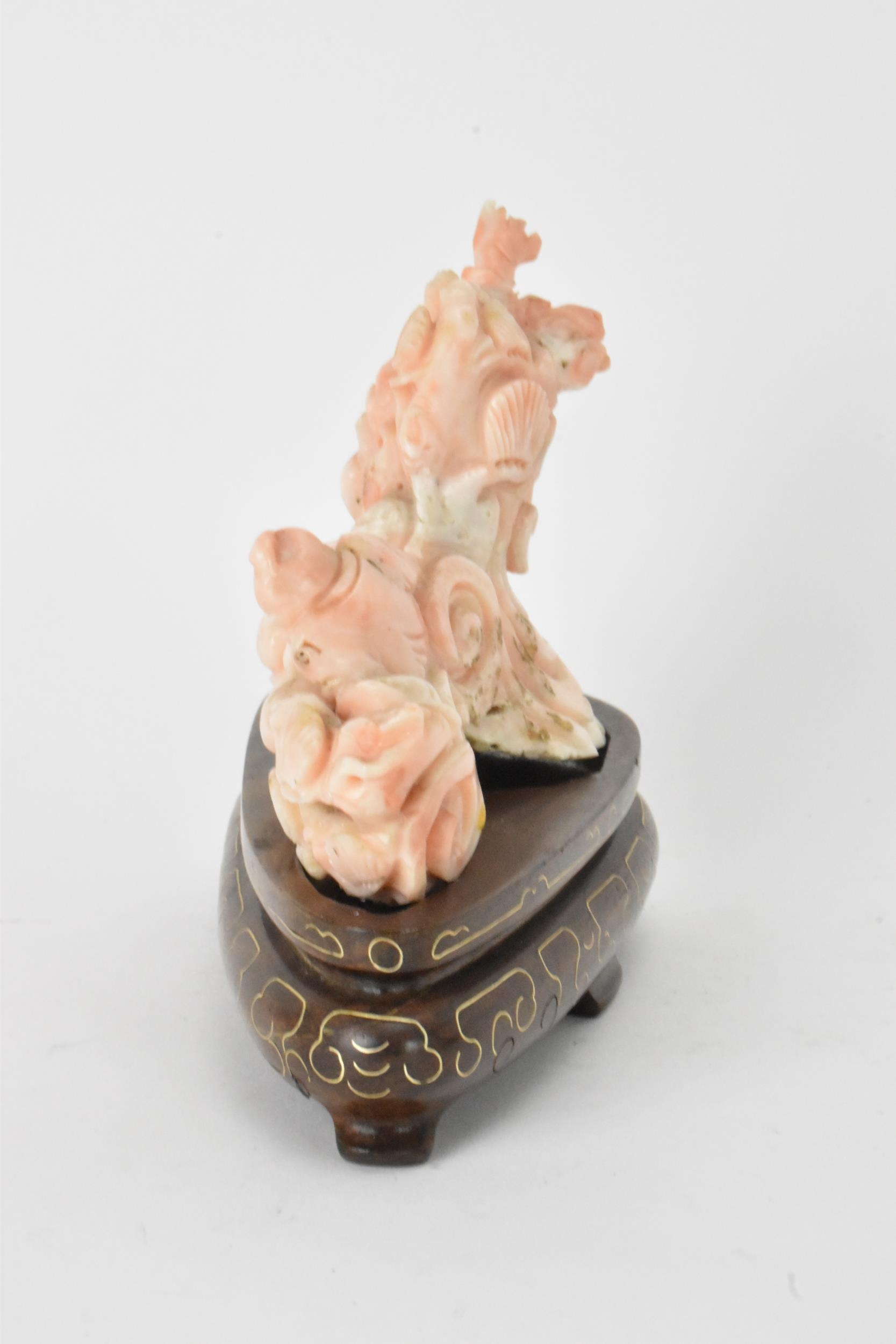 A Chinese 20th century coral carving depicting a laughing Buddha with child among a nautical - Image 2 of 6
