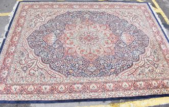 An early 20th century handwoven Indian Agra rug, with central floral medallion on a navy ground,